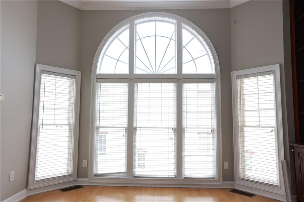 3541 Roswell Road Northeast, Unit 20 Atlanta, GA 30305 - Photo 50 of 72 an empty room with wooden floor and windows