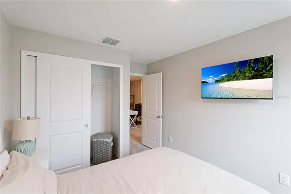 a bedroom with a bed and a flat screen tv