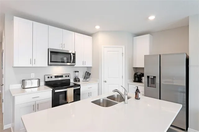 a kitchen with a sink a stove and refrigerator