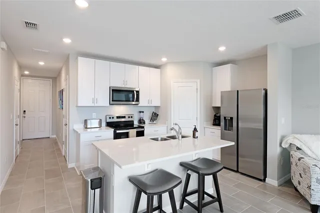 a kitchen with stainless steel appliances a refrigerator stove microwave and cabinets