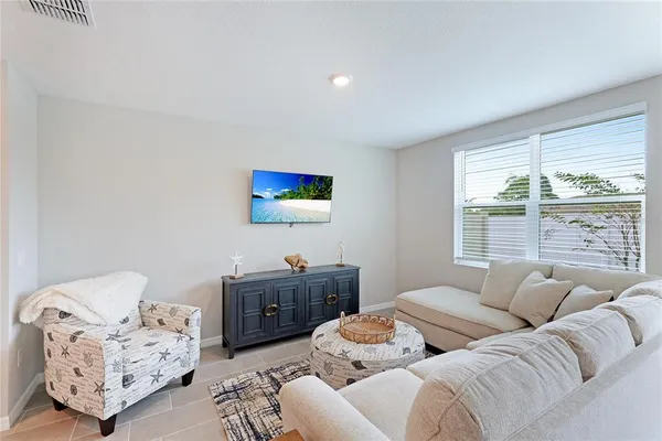 a living room with furniture and a large window