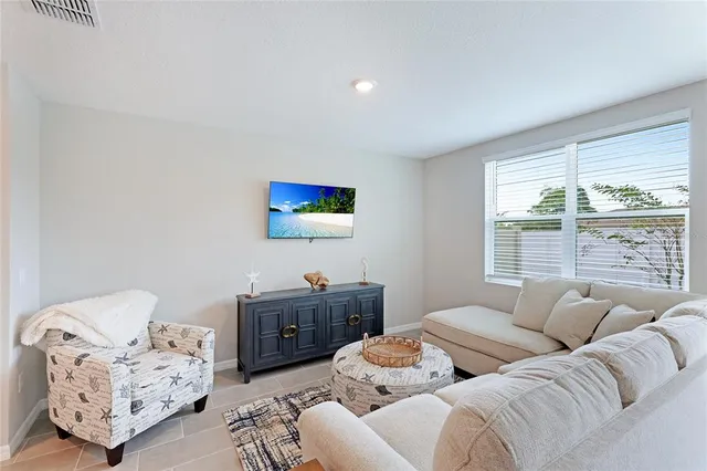 a living room with furniture and a large window