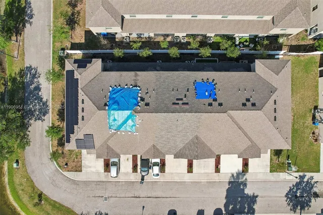 an aerial view of residential building and lake