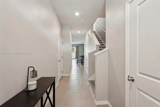 a kitchen with kitchen island granite countertop a stove top oven a sink a dining table and chairs with wooden floor