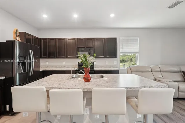 a kitchen with a sink and a wooden floor