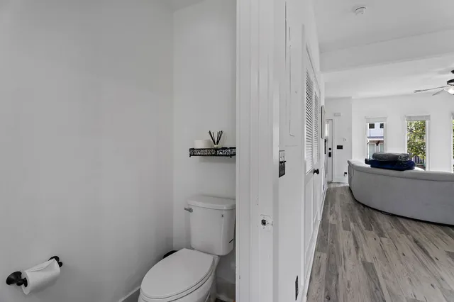 a bathroom with a granite countertop bathtub sink vanity mirror and toilet