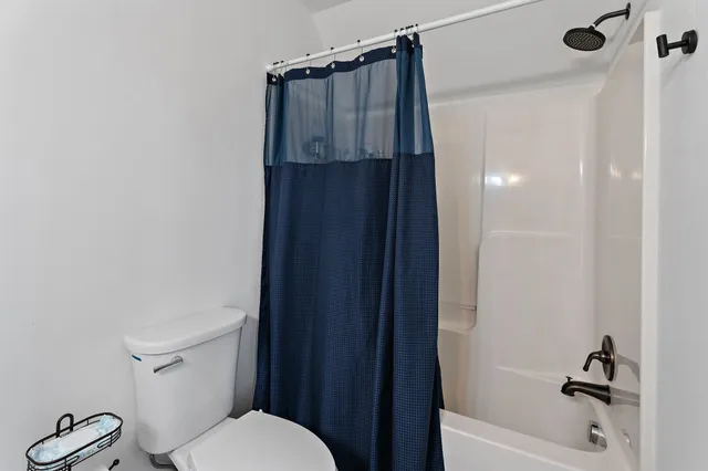 a bathroom with a shower and a toilet