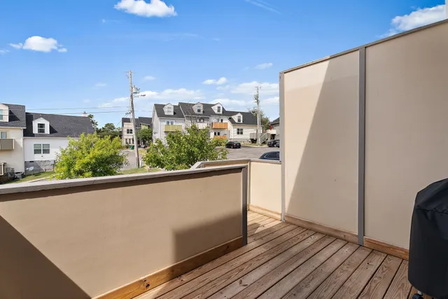 a view of a kitchen with wooden floor and a window