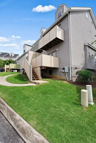 a view of a back yard of the house with a yard