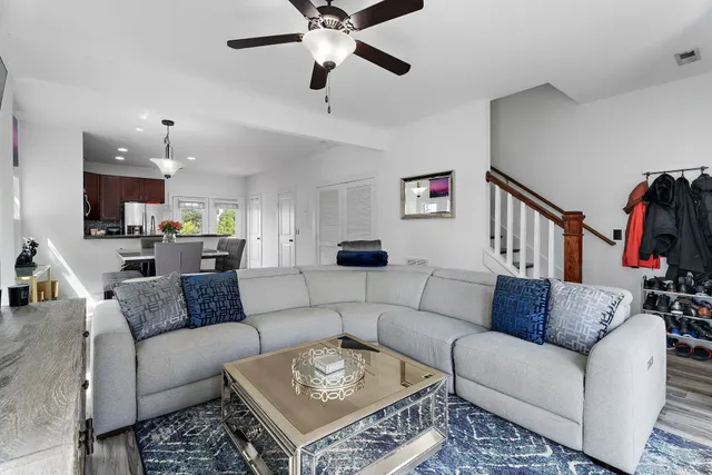a living room with furniture and a view of kitchen