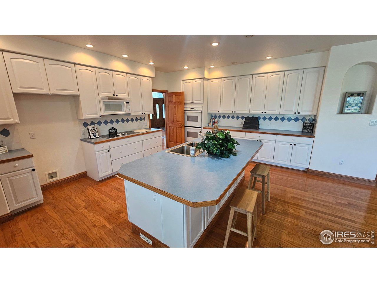 17606 County Road Q Fort Morgan, CO 80701 - Photo 16 of 37 a kitchen with stainless steel appliances kitchen island granite countertop a sink a stove and a refrigerator