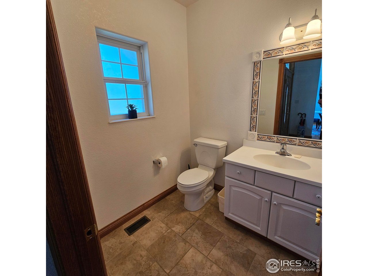 17606 County Road Q Fort Morgan, CO 80701 - Photo 23 of 37 a bathroom with a sink a toilet and mirror