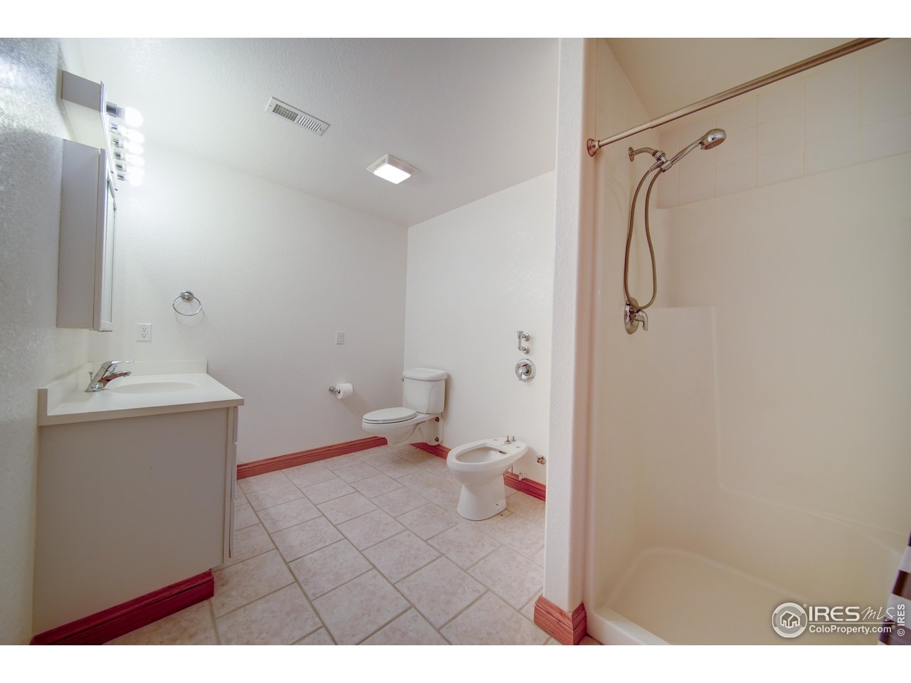 17606 County Road Q Fort Morgan, CO 80701 - Photo 34 of 37 a bathroom with a sink mirror vanity and toilet