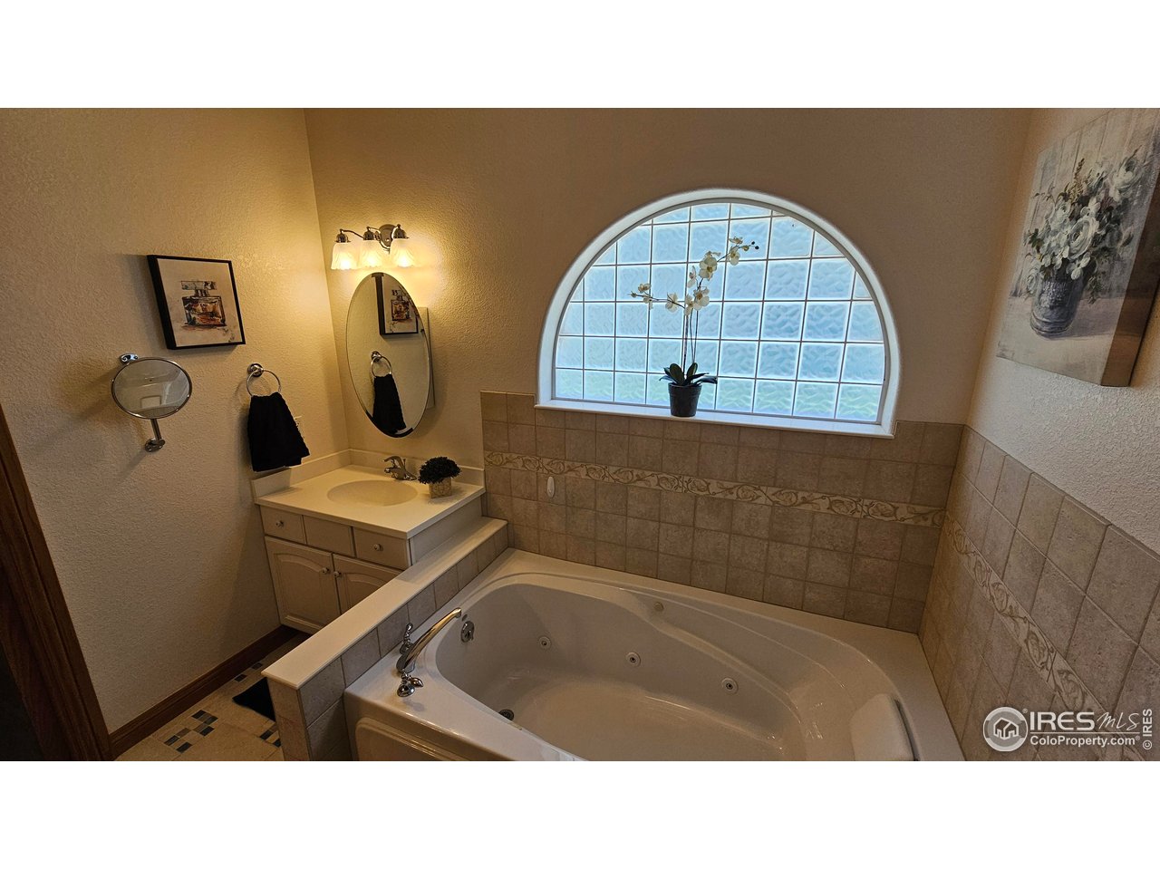 17606 County Road Q Fort Morgan, CO 80701 - Photo 9 of 37 a bathroom with a sink mirror and vanity