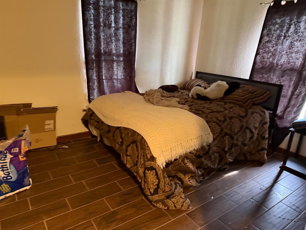 4050 Old Anson Road Abilene, TX 79601 - Photo 29 of 40 a bedroom with a bed and wooden floor