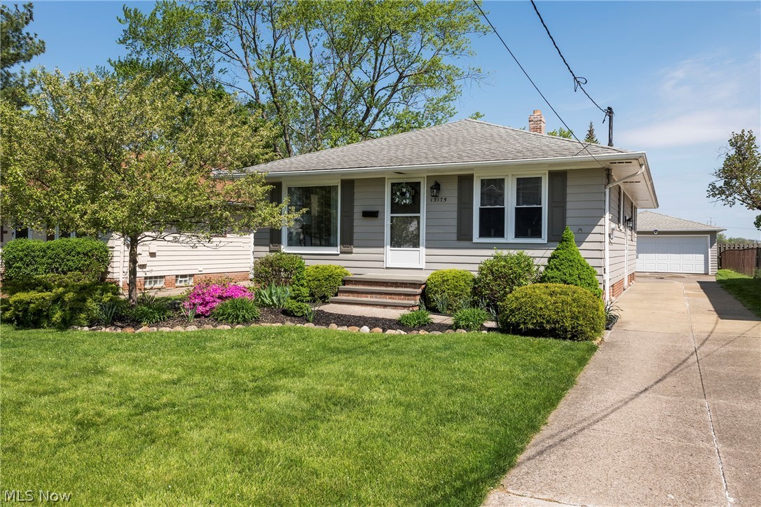 13175 McCracken Road Cleveland, OH 44125 - Photo 2 of 48 View of front of house featuring a front yard and a garage
