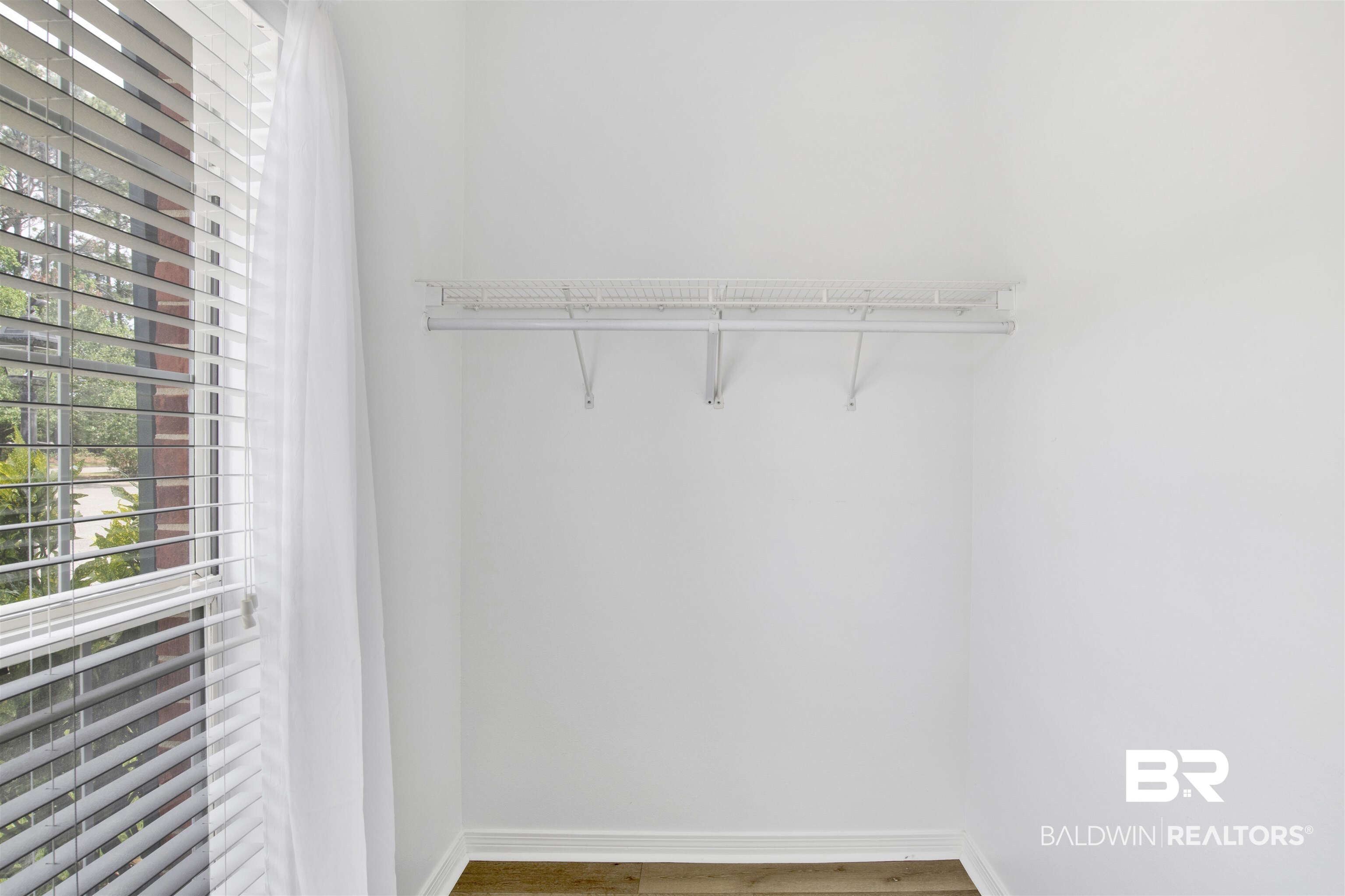 1258 Sutton Court, Unit 4 Mobile, AL 36609 - Photo 14 of 19 Walk in closet with wood finished floors