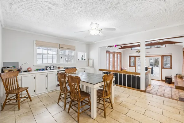 a spacious bedroom with a bed a mirror on dresser and a window