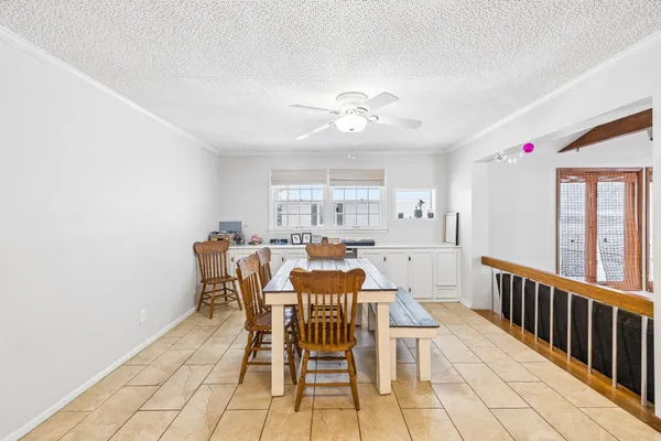 a bedroom with a large bed a flat tv screen and dresser