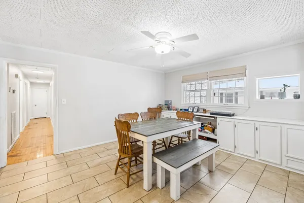 a bedroom with a large bed a flat tv screen and dresser