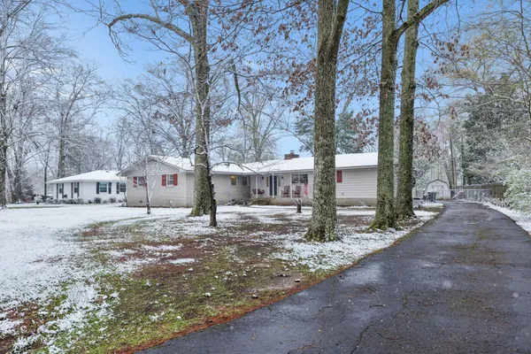a backyard of a house with barbeque oven and wooden fence
