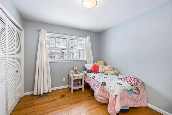 a view of house with a bench in the backyard