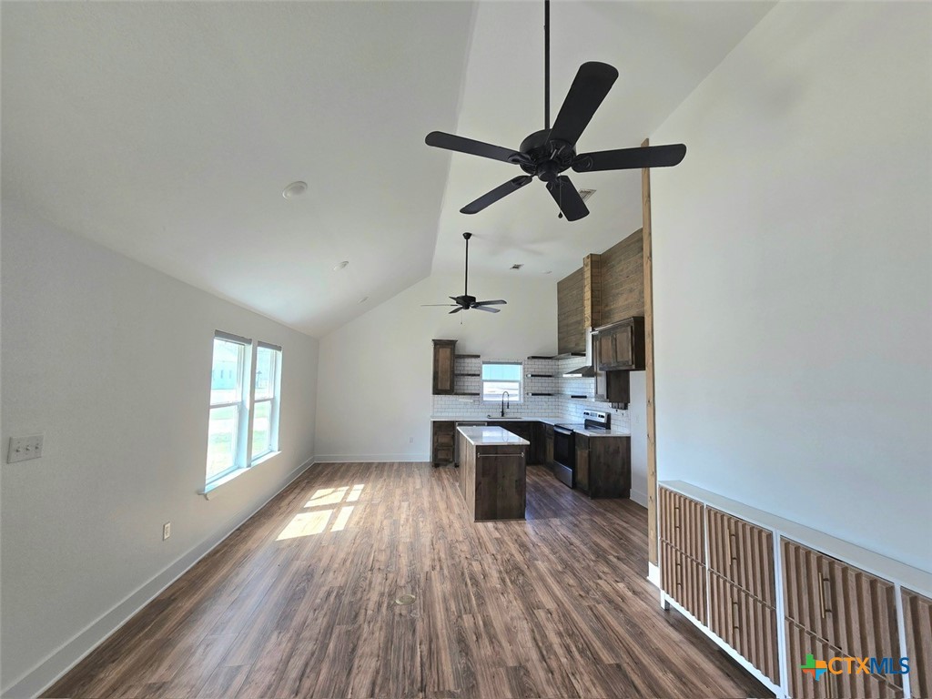 1005 Bridge Street Lampasas, TX 76550 - Photo 11 of 29 a dining room with kitchen island wooden floor and stainless steel appliances