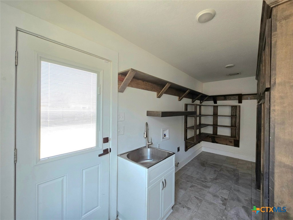 1005 Bridge Street Lampasas, TX 76550 - Photo 15 of 29 a kitchen with a refrigerator and window