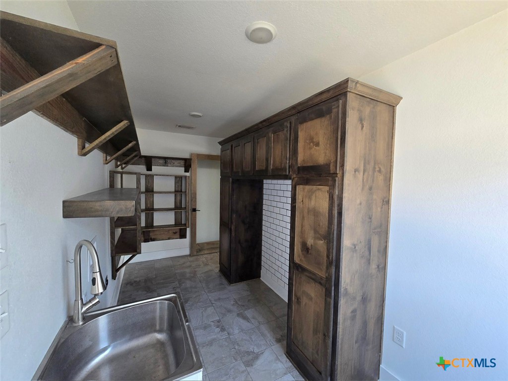 1005 Bridge Street Lampasas, TX 76550 - Photo 16 of 29 a view of living room with furniture and a refrigerator