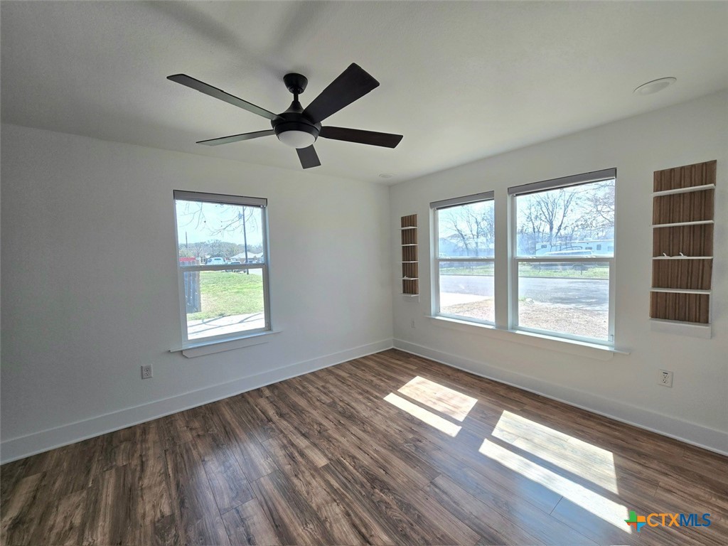 1005 Bridge Street Lampasas, TX 76550 - Photo 23 of 29 a view of an empty room with wooden floor and a window