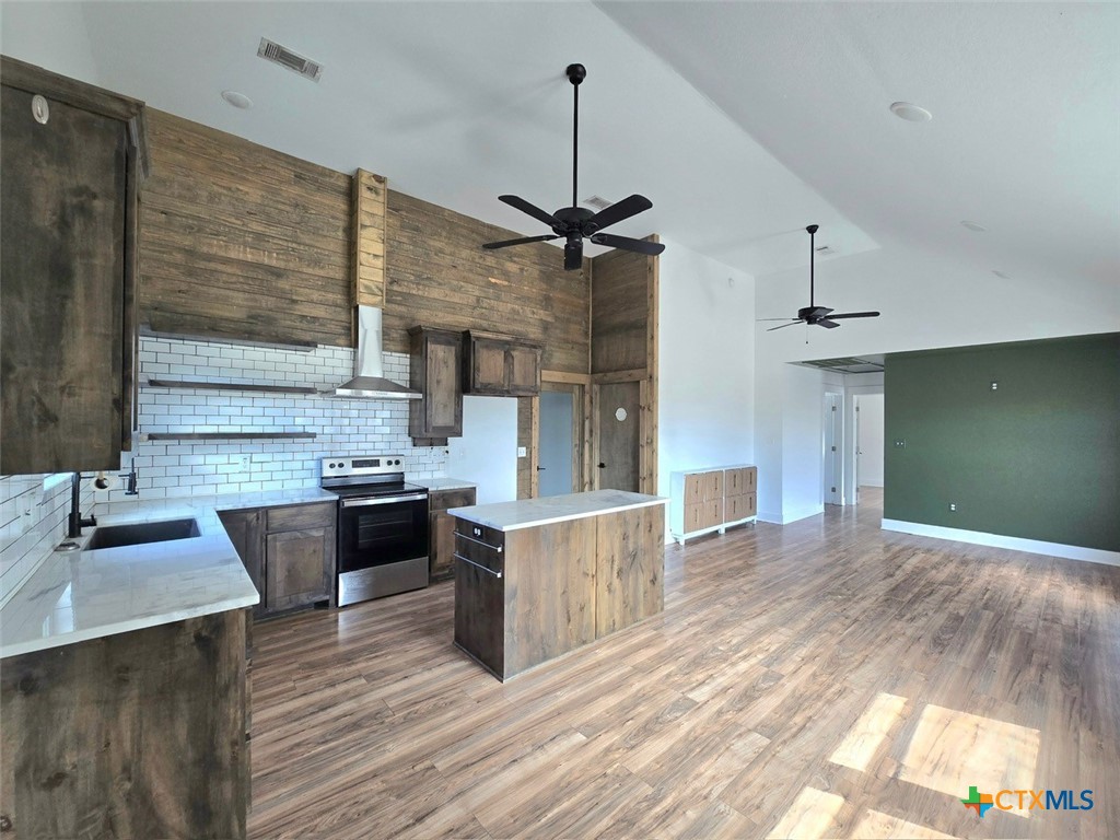 1005 Bridge Street Lampasas, TX 76550 - Photo 6 of 29 a kitchen with stainless steel appliances granite countertop a sink stove and refrigerator