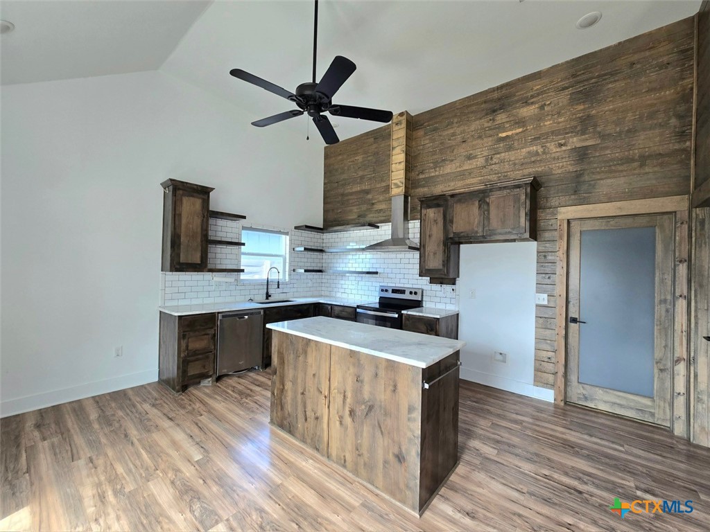 1005 Bridge Street Lampasas, TX 76550 - Photo 7 of 29 a kitchen with stainless steel appliances a stove refrigerator and a sink