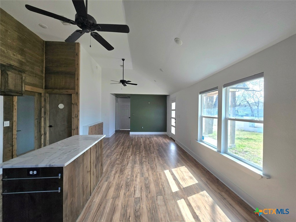 1005 Bridge Street Lampasas, TX 76550 - Photo 9 of 29 a view of empty room with wooden floor and fan