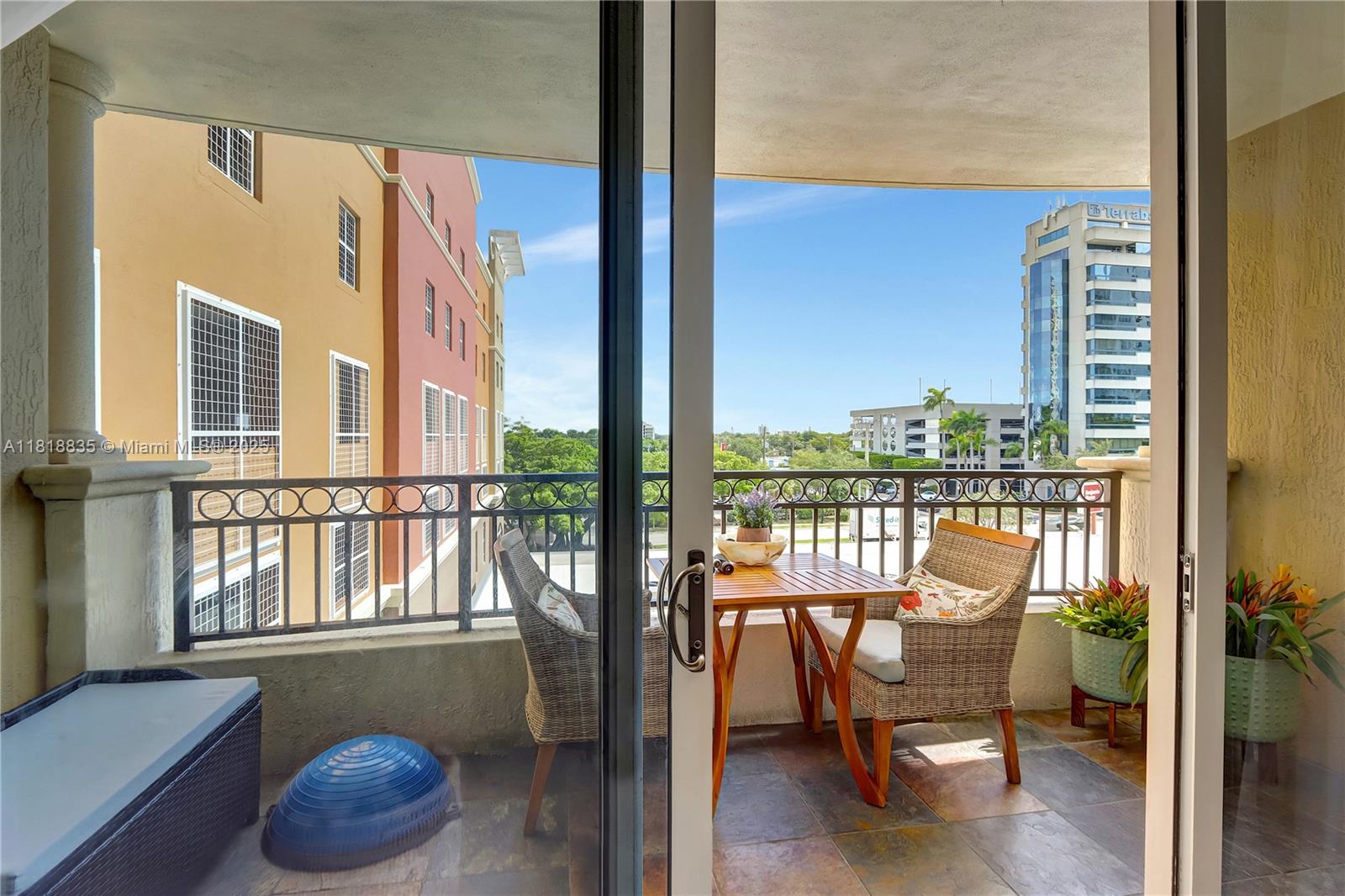 3232 Southwest 22nd Terrace, Unit 404 Miami, FL 33145 - Photo 11 of 21 a balcony with table and chairs