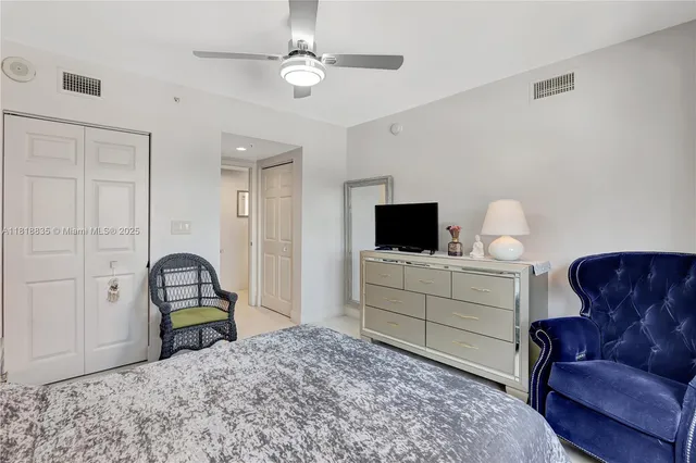 a bedroom with a bed and a television