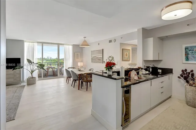 a kitchen with granite countertop a stove a sink and a refrigerator