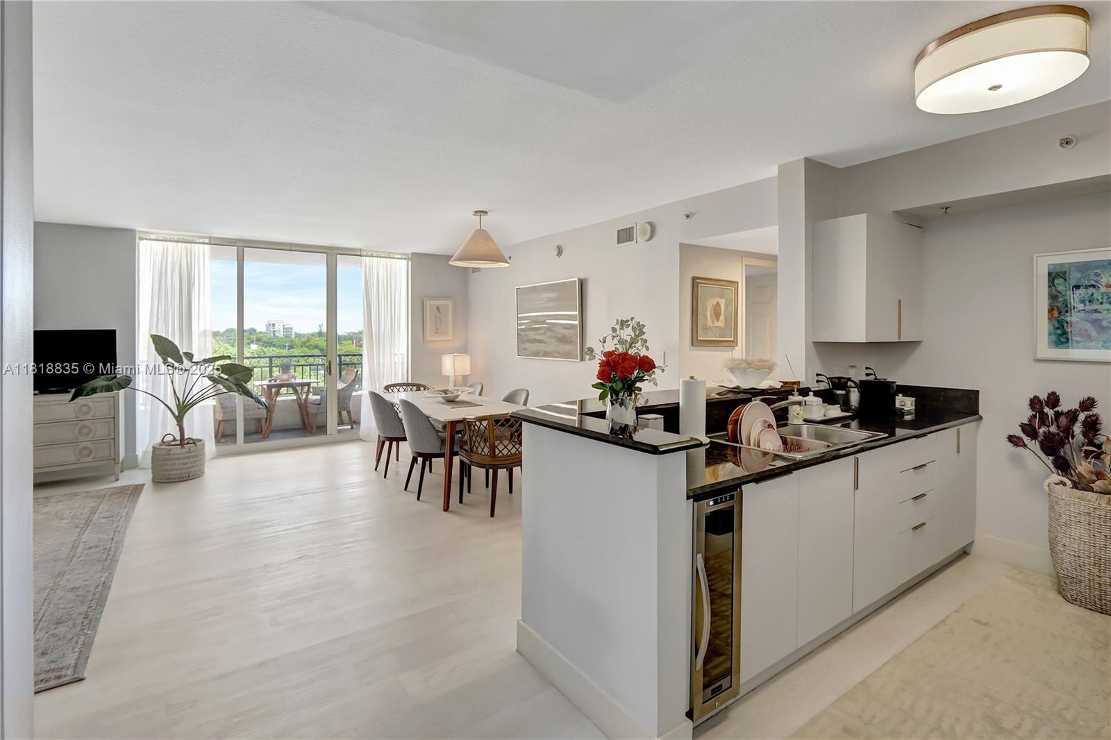 3232 Southwest 22nd Terrace, Unit 404 Miami, FL 33145 - Photo 6 of 21 a kitchen with granite countertop a stove a sink and a refrigerator