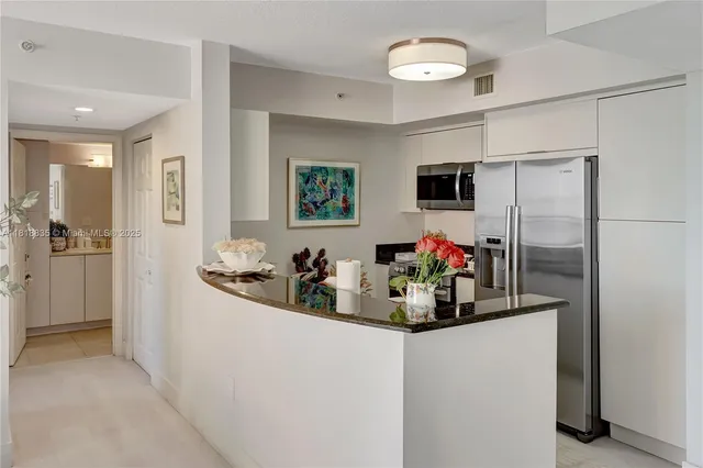 a view of a refrigerator and a sink