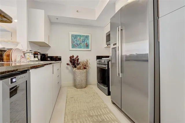 a kitchen with a refrigerator and a sink