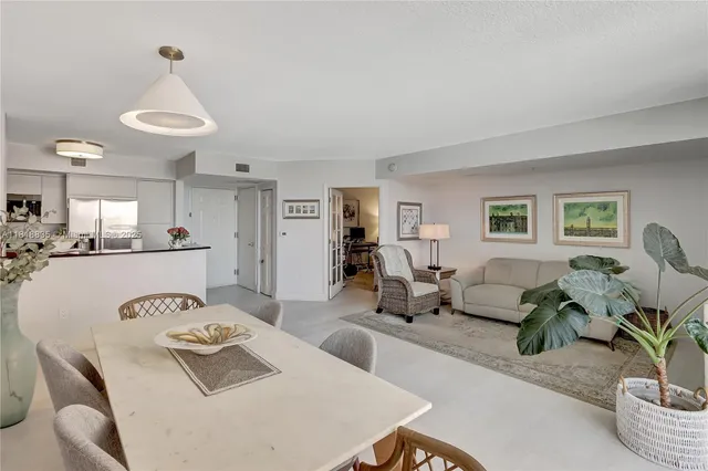 a living room with furniture and a dining table