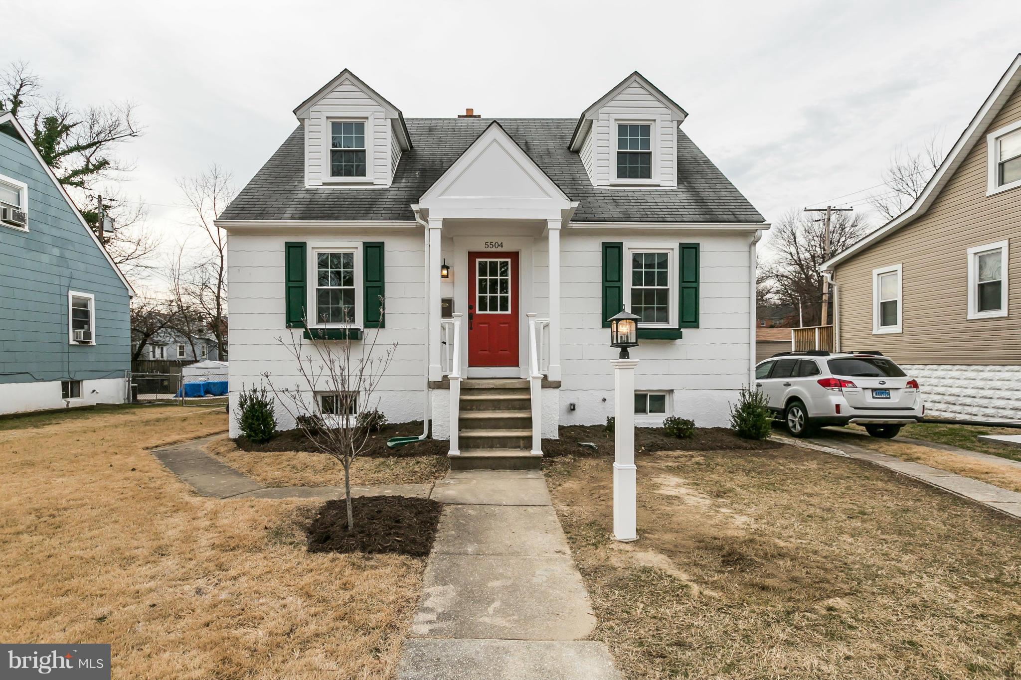 5504 Catalpha Road Baltimore, MD 21214 - Photo 2 of 28 a view of a white house with a large windows next to a road