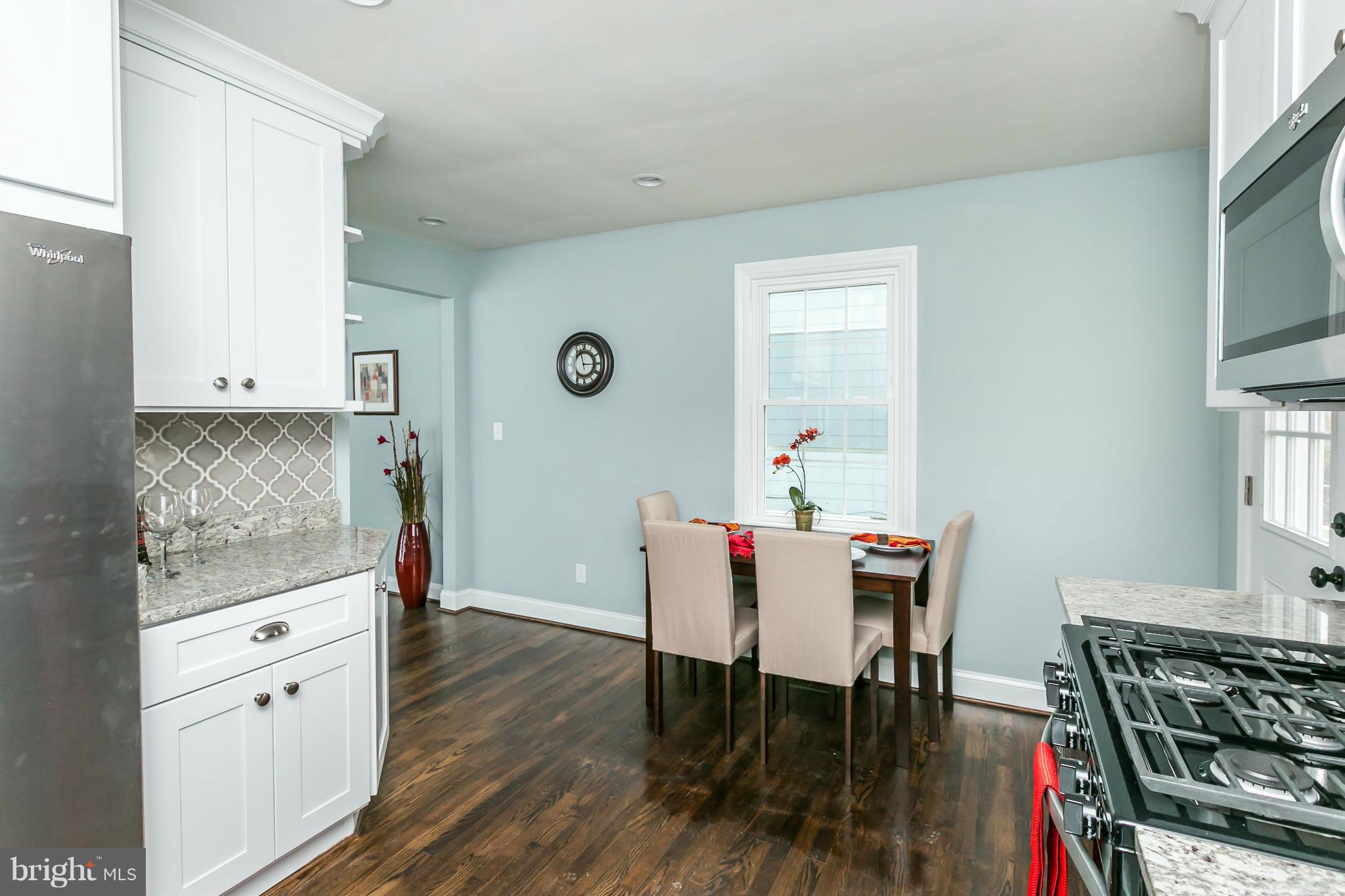 5504 Catalpha Road Baltimore, MD 21214 - Photo 11 of 28 a dining room with furniture and wooden floor