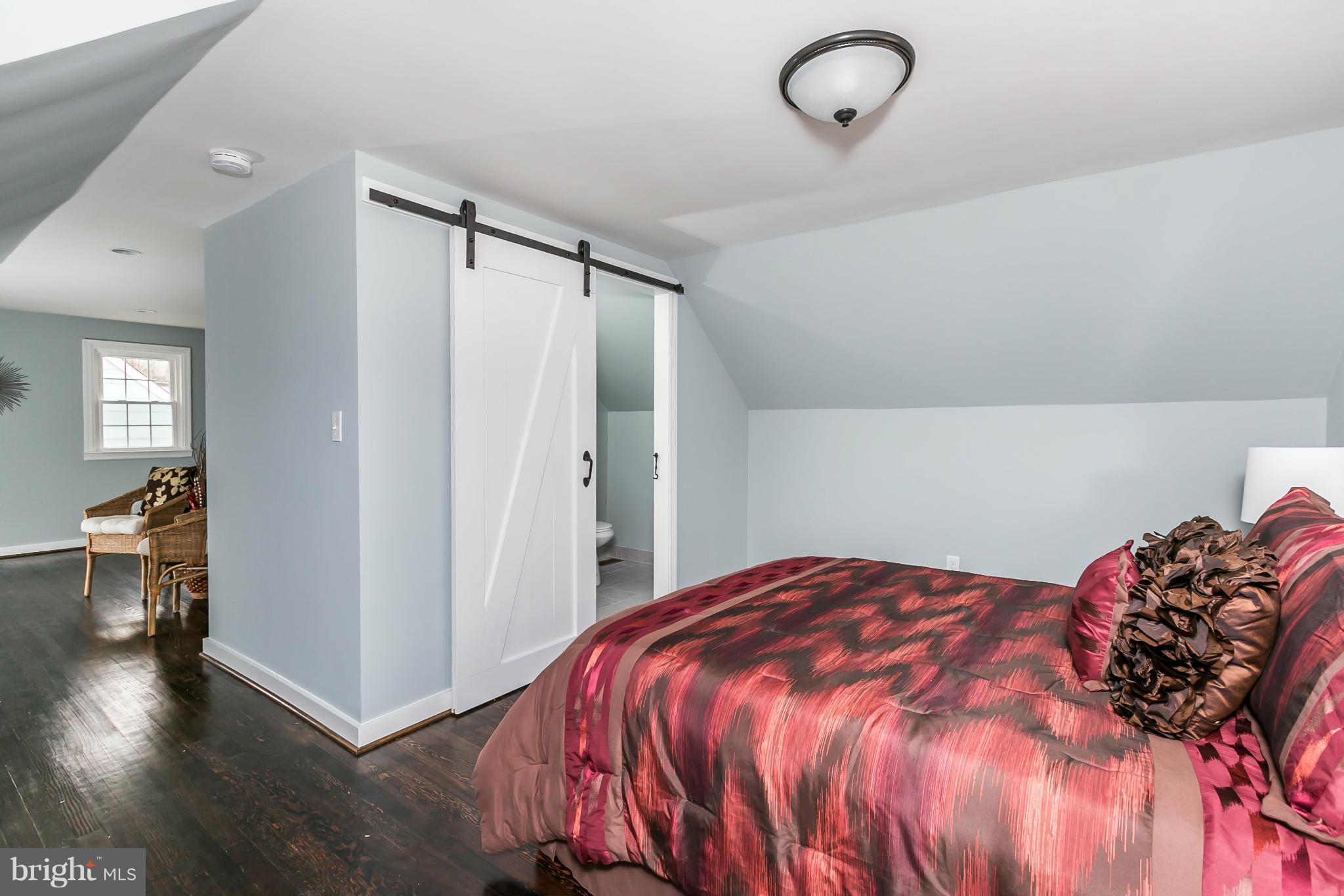 5504 Catalpha Road Baltimore, MD 21214 - Photo 16 of 28 a bedroom with a bed and a walk in closet