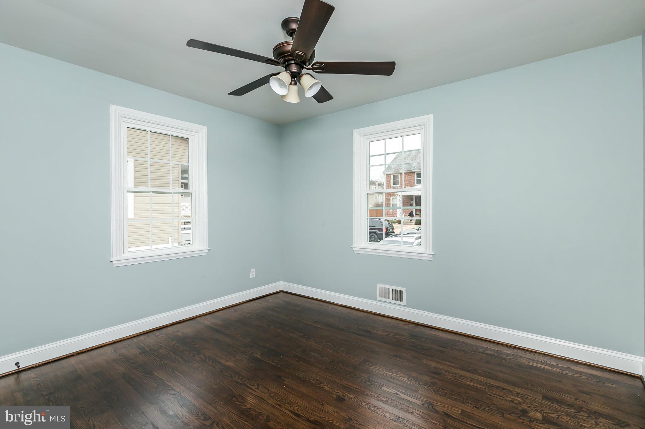 5504 Catalpha Road Baltimore, MD 21214 - Photo 18 of 28 a view of a big room with wooden floor and windows