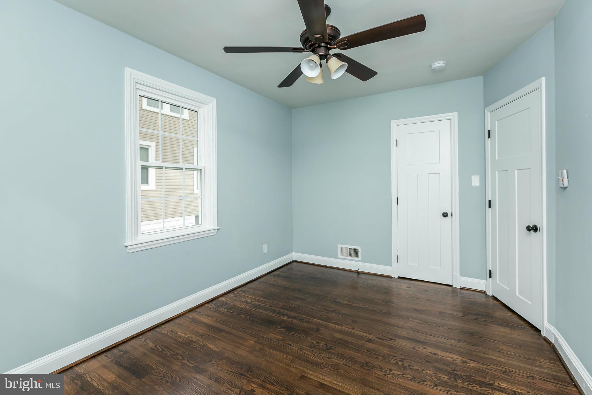 5504 Catalpha Road Baltimore, MD 21214 - Photo 20 of 28 wooden floor in an empty room with a window