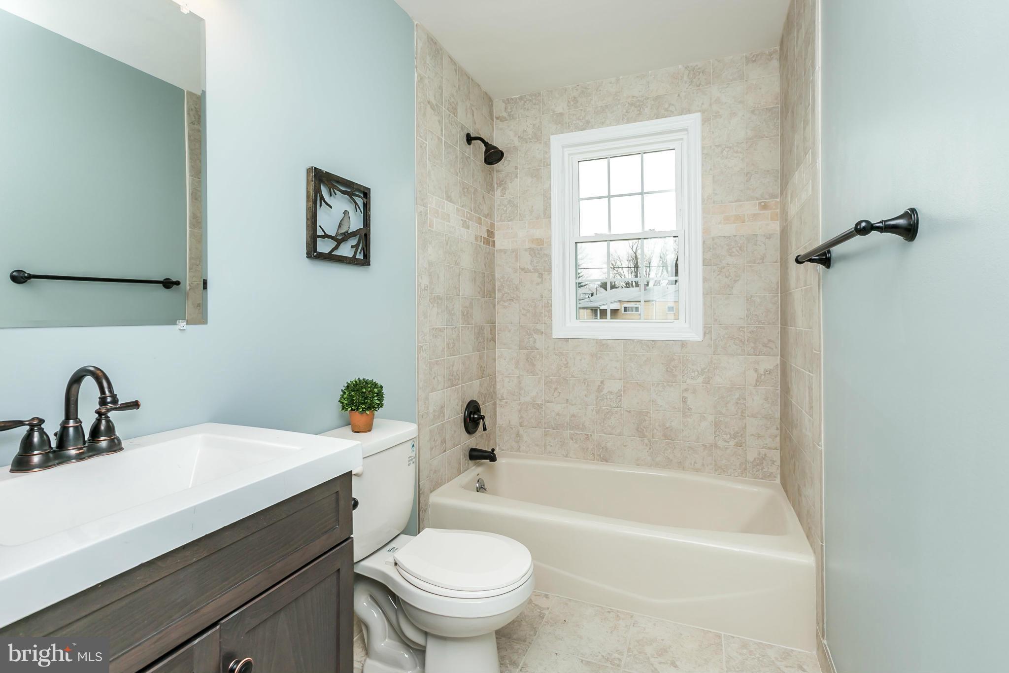 5504 Catalpha Road Baltimore, MD 21214 - Photo 21 of 28 a bathroom with a sink a toilet and bathtub
