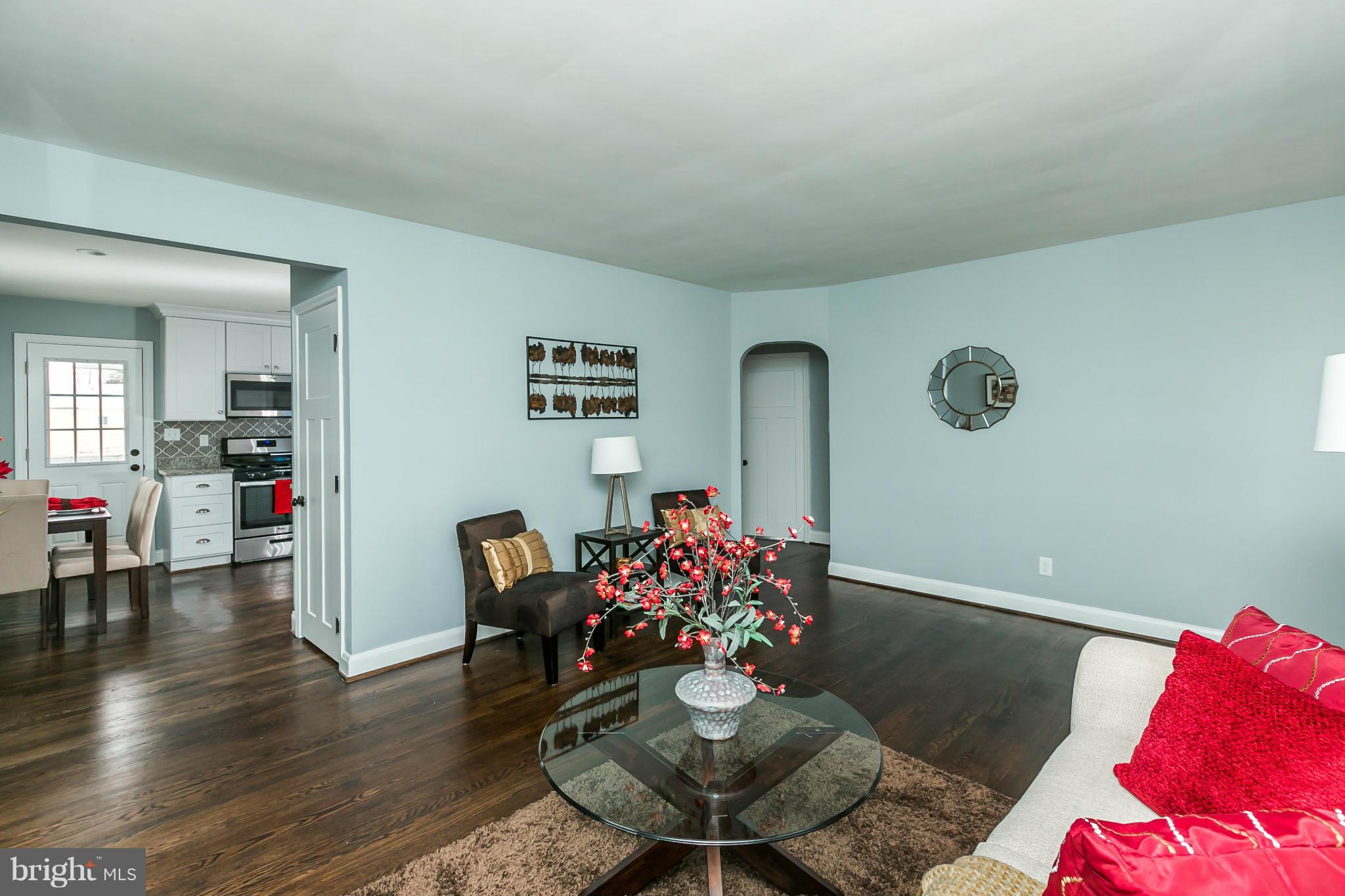 5504 Catalpha Road Baltimore, MD 21214 - Photo 5 of 28 a living room with furniture and wooden floor