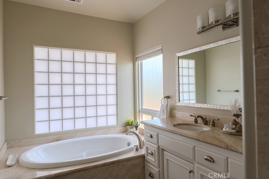 755 Willow Road Nipomo, CA 93444 - Photo 29 of 43 Master bathroom with soaking tub and separate walk in shower. Custom dual sink vanity adds to the elegance