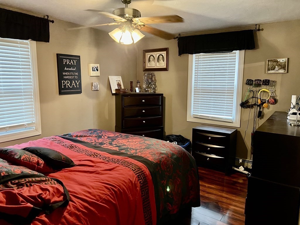 30 Tennyson Street Worcester, MA 01610 - Photo 11 of 19 a bedroom with a bed and a chandelier