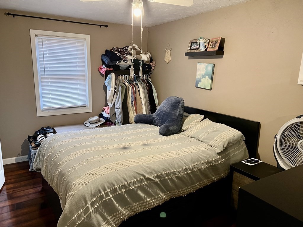 30 Tennyson Street Worcester, MA 01610 - Photo 10 of 19 a bedroom with a bed and a chandelier